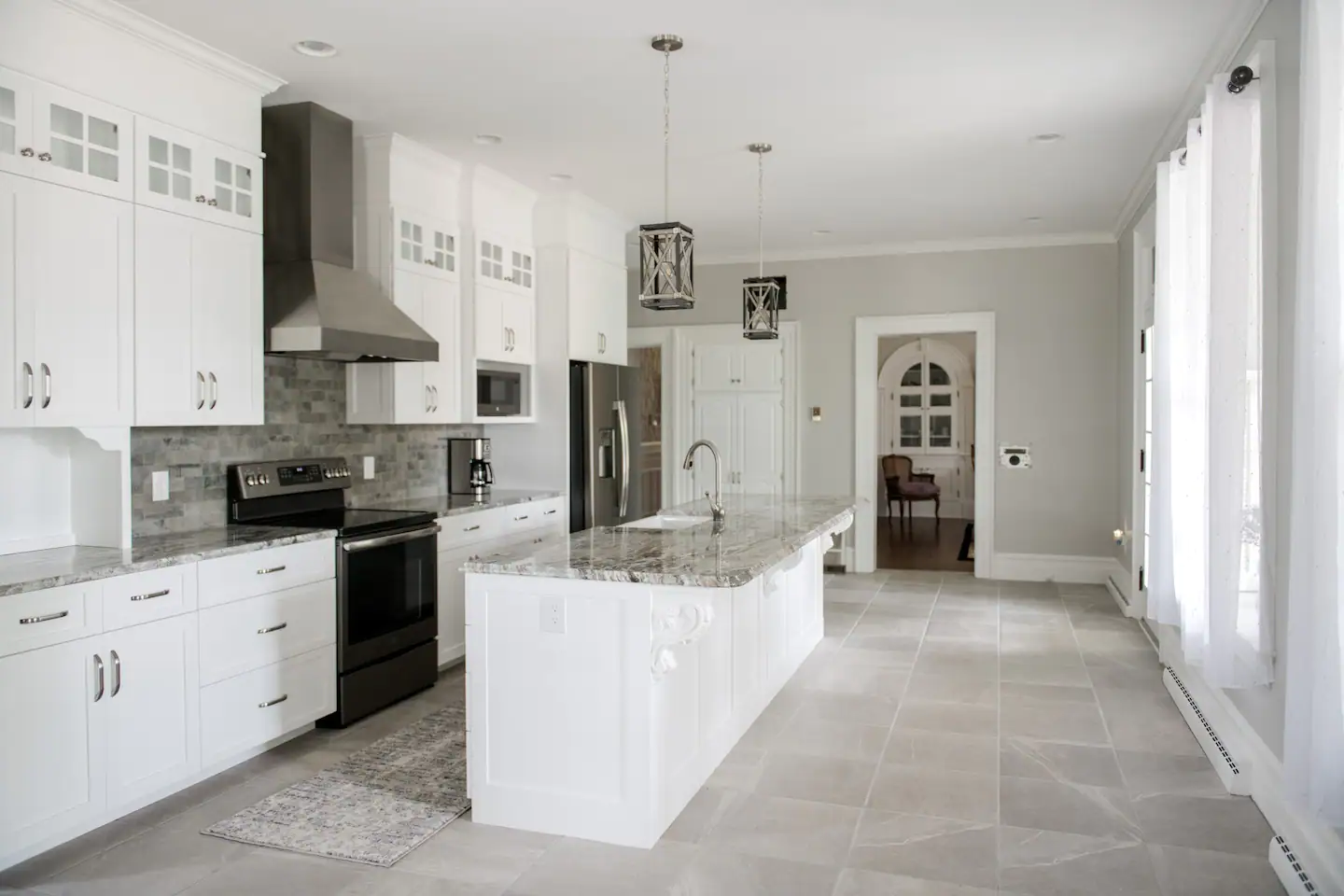 Kitchen with seating for eight at the table and 3 barstools.