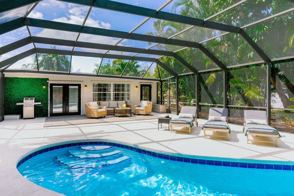 Large pool deck surrounded by lush landscaping